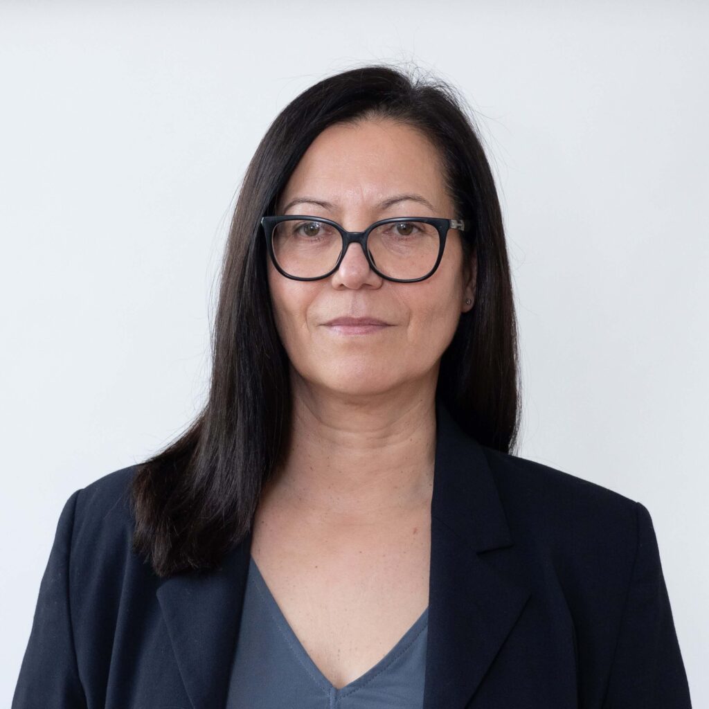 Zdjęcie Monkiewicz. Jest w czarnej marynarce i szarnej bluzce. Ma okulary z czarnymi oprawkami.
