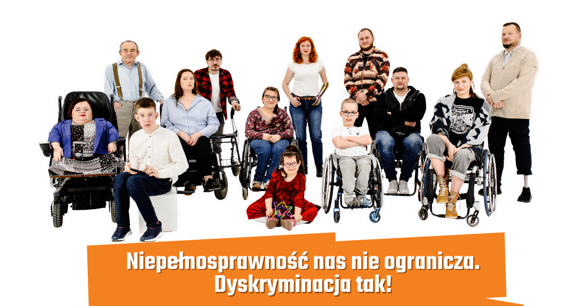 Grupa osób z niepełnosprawnościami (dorośli i dzieci) pozują do grupowego zdjęcia.